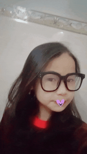 a girl wearing glasses has a pink heart on her nose