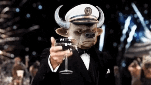 a bull in a suit and hat is holding a glass of wine .