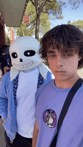 a man in a purple shirt is standing next to a man in a skeleton mask