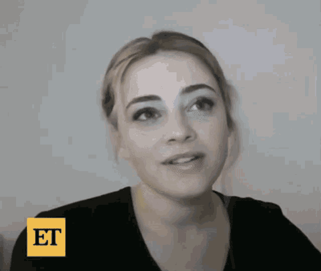 a close up of a woman 's face with the word et on the bottom right