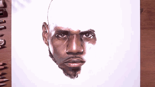 a drawing of a man 's face with a pencil on a piece of paper