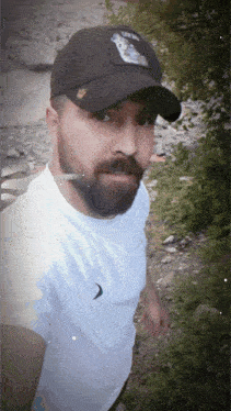 a man with a beard wearing a hat that says lion