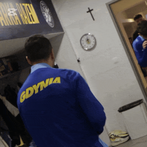 a man in a blue jacket that says gdynia on the back