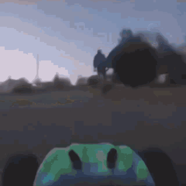 a blurry picture of a person riding a skateboard on a road .