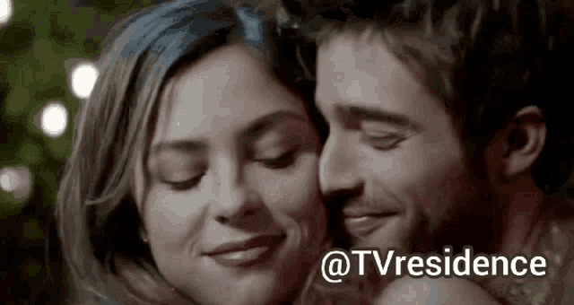 a man and a woman are hugging each other with the words tv residence written on the bottom .