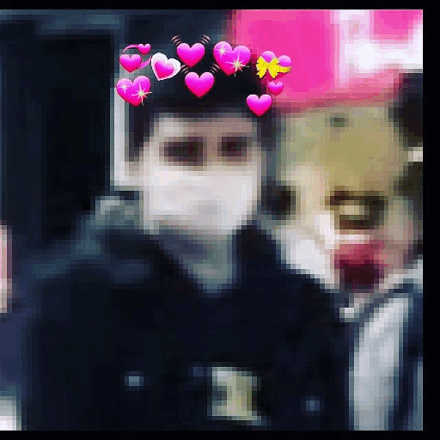 a blurry picture of a person wearing a mask with hearts around their head