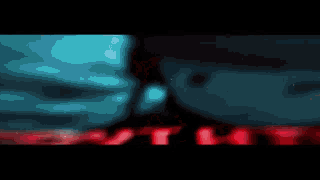 a blurred image of a person wearing sunglasses and a red background .