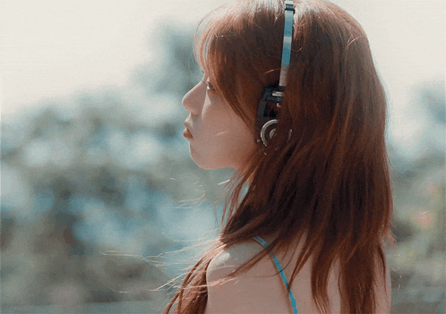 a woman wearing a pair of headphones with the letter c on the bottom