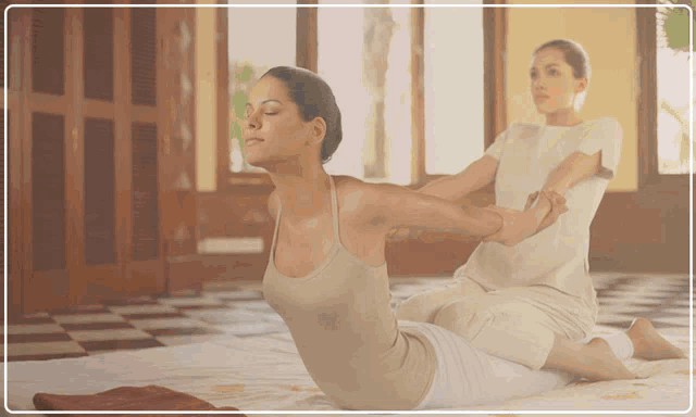 a woman is getting a massage while sitting on the floor