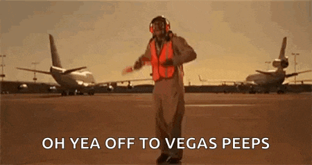 a man in an orange vest and headphones is dancing on an airport runway .