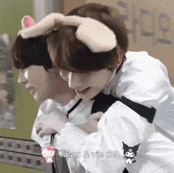 a boy wearing bunny ears is carrying a girl on his back .