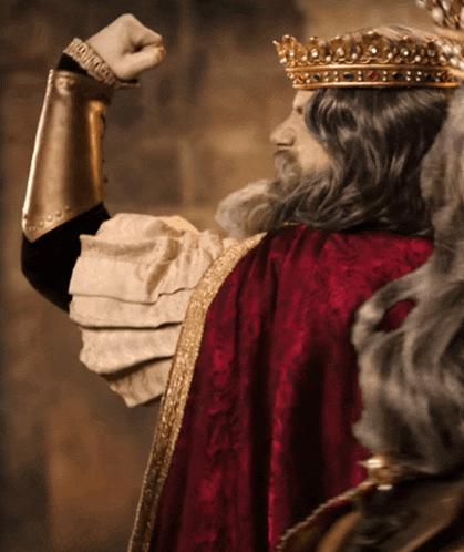 a statue of a man wearing a crown and a red cape