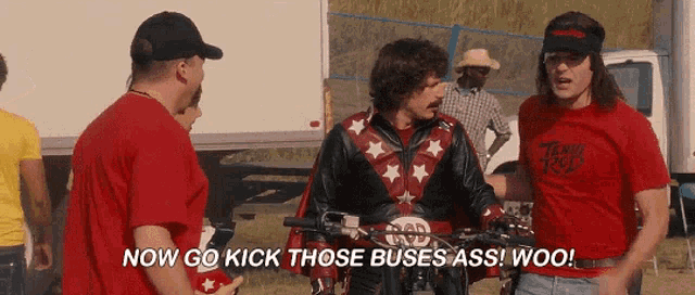 a man on a motorcycle says " now go kick those buses ass woo! "