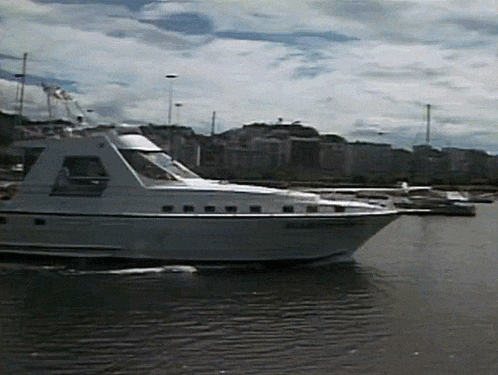 a large white boat with a black stripe on the side is floating in a body of water