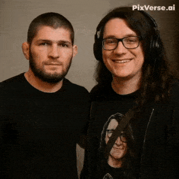 a man wearing headphones stands next to a man with long hair