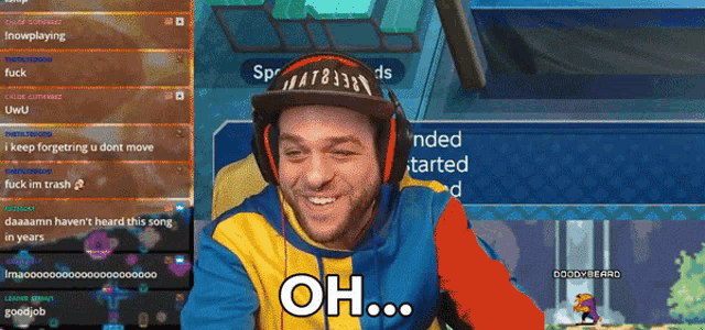 a man wearing a hat and headphones is playing a video game and says oh on the screen