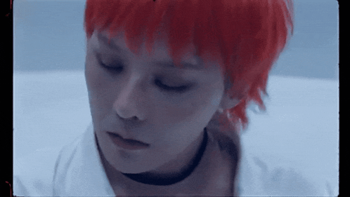 a close up of a person 's face with red hair and a choker .