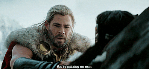 a man in a fur coat is talking to another man who is missing an arm .