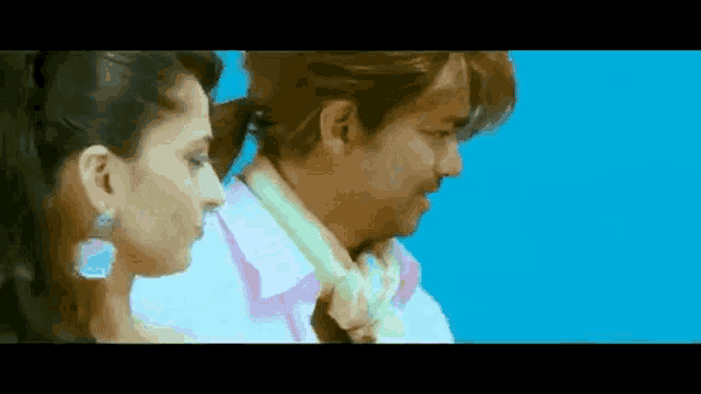 a man and a woman are standing next to each other .