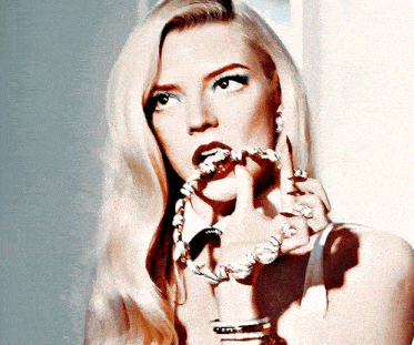 a woman with long blonde hair is wearing a necklace and bracelets