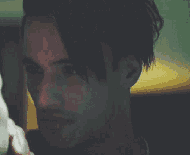 a close up of a man 's face with long hair