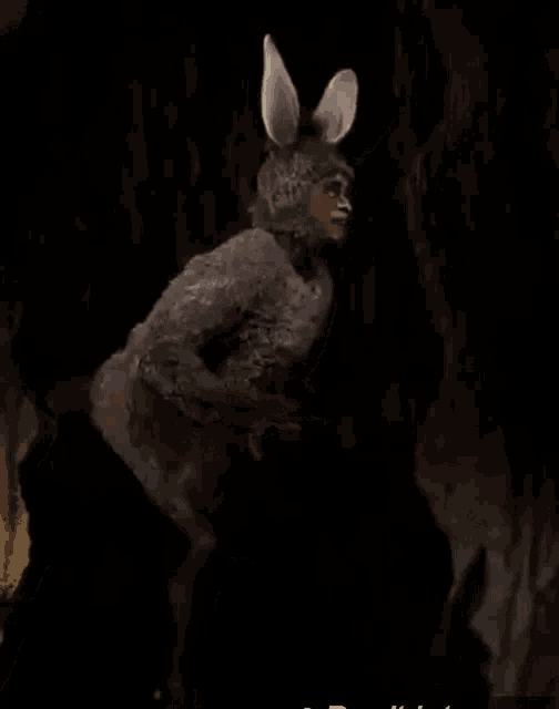 a man in a donkey costume is standing in a tree