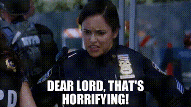 a woman in a police uniform is standing in front of a group of police officers .