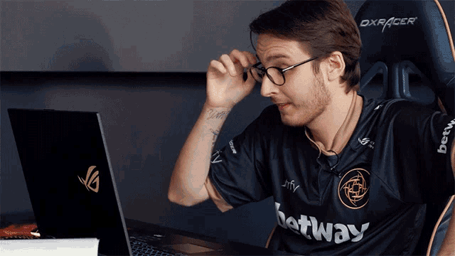 a man wearing glasses and a black shirt that says ' betway ' on it