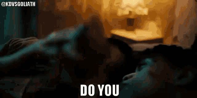 a person is laying on a bed with the words `` do you '' written on the bottom .