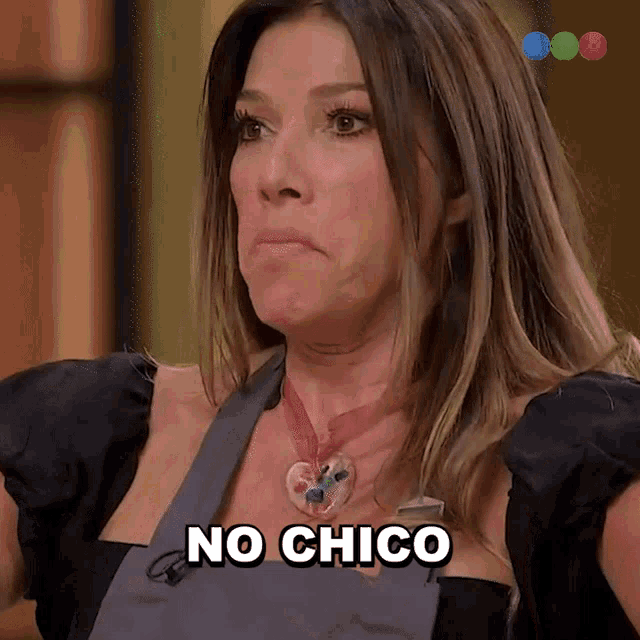 a woman with a heart shaped necklace is saying no chico