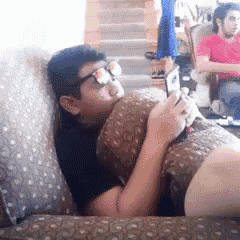 a man wearing sunglasses is laying on a couch with a woman