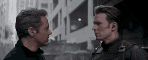 two men are standing next to each other and looking at each other