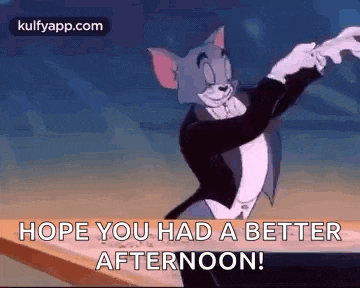 tom from tom and jerry is wearing a tuxedo and a bow tie and holding a baton .