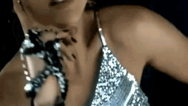 a close up of a woman wearing a sequined top