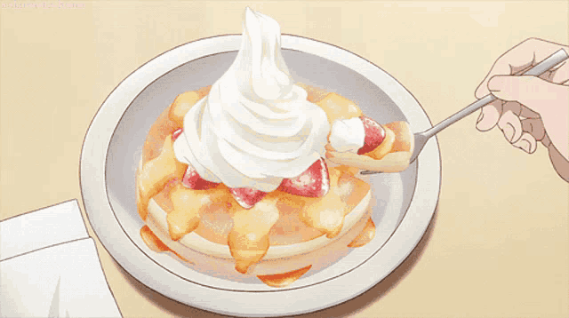 a person is eating a pancake with whipped cream on top
