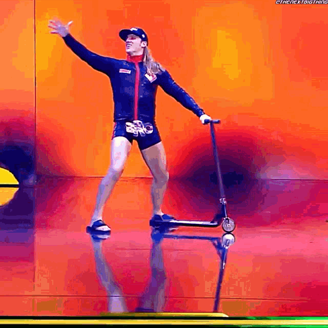 a man riding a scooter on a stage with the hashtag #thenextbig thing