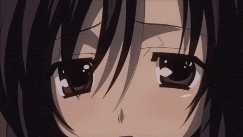 a close up of a girl 's face with a sad expression