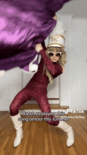 a tiktok video of a woman in a leopard print jumpsuit and white boots