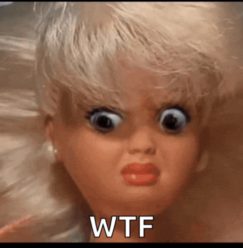 a close up of a doll 's face with the words wtf on the bottom