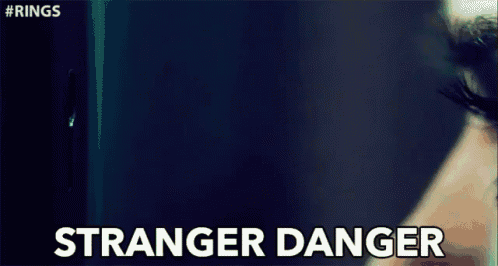 a close up of a woman 's eye with the words `` stranger danger '' written on the bottom .
