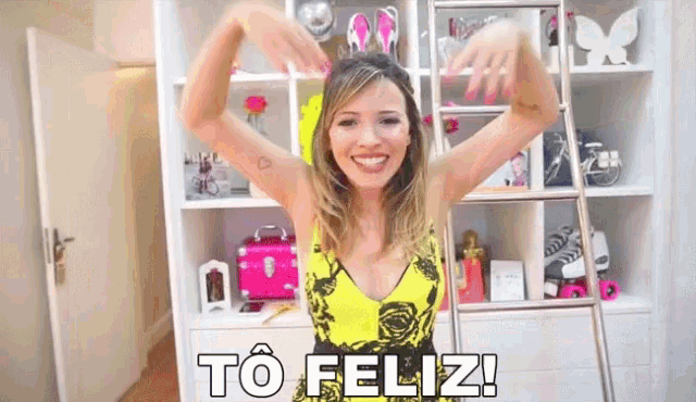 a woman in a yellow dress says to feliz in a room