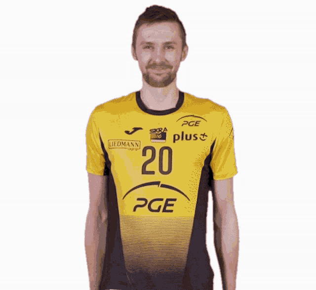 a man is wearing a yellow and black pge shirt