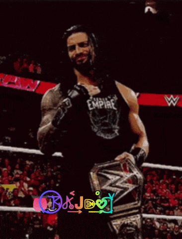 roman reigns is holding the world heavyweight championship belt