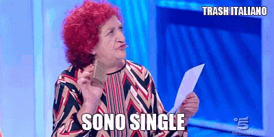 an older woman with red hair is holding a piece of paper and says sono single