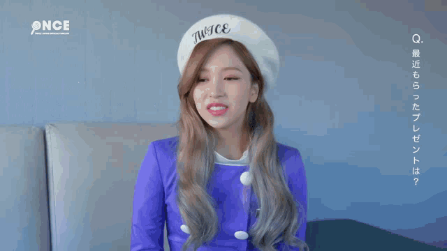 a woman wearing a beret that says once on it