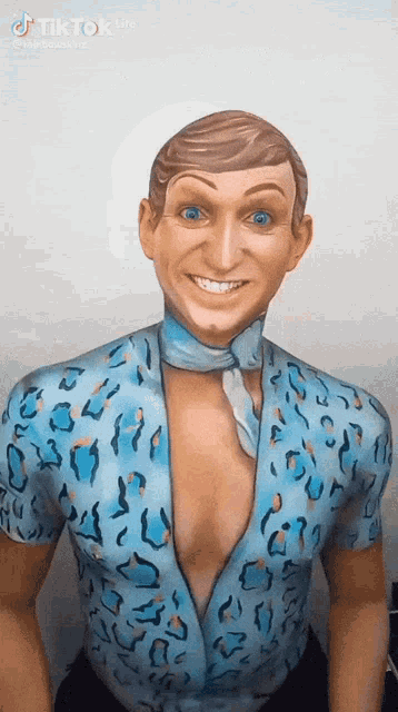 a man with his body painted in a blue shirt and tie