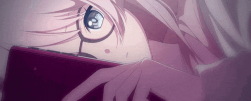 a girl with glasses is laying down and looking at a cell phone