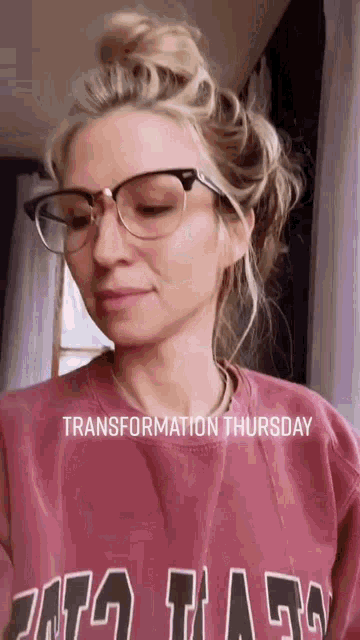 a woman wearing glasses and a pink shirt with the words transformation thursday on it