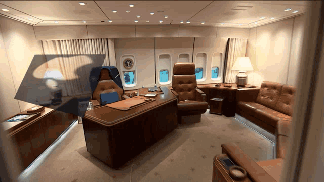 a room with a couch and a desk with a clock on the wall that says ' united states of america '