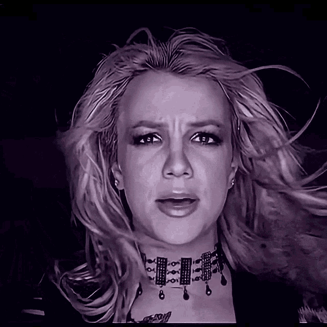 a close up of a woman 's face with a choker around her neck that says ' britney spears ' on it
